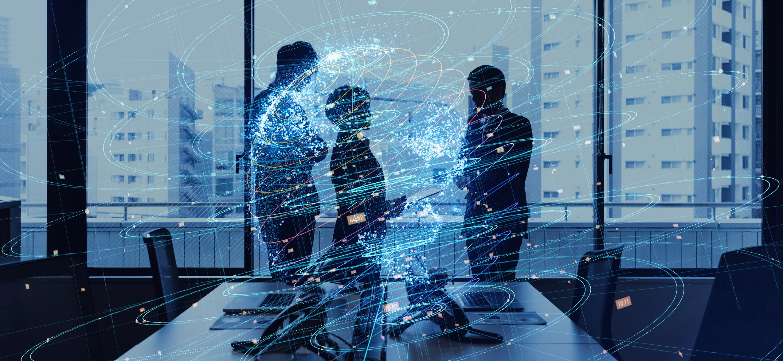 Mission e valori Protos | Protos Group Three professionals in a glass conference room with swirling digital data streams around them. | Protos Group